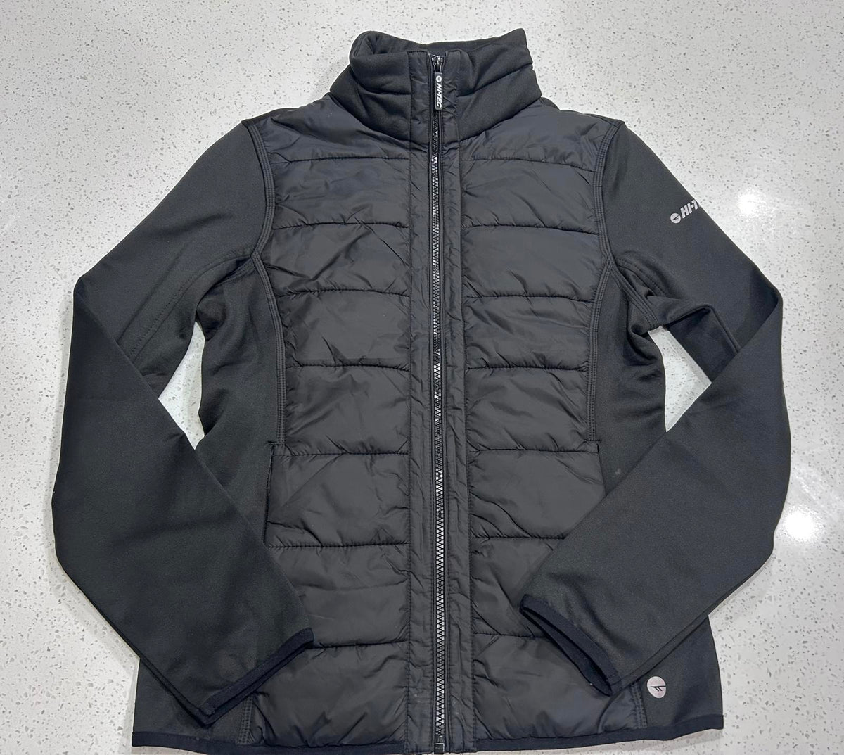 Hi-Tec branded black women's hybrid softshell and quilted puffer jacket